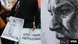 Anti-government protesters hold posters asking who killed opposition leader Boris Nemtsov as they march during an opposition rally in Moscow, Russia, on Sunday, Sept. 20, 2015. (photo by M. Eckels)
