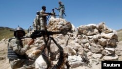 FILE - Afghan border policemen take their positions at the Goshta district of Nangarhar province border, where Afghanistan shares borders with Pakistan.