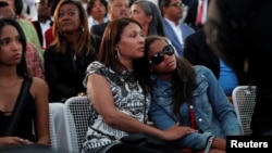 One of Aretha Franklin's granddaughters (R) is comforted as she sheds tears during a live rendition of Amazing Grace at a free tribute concert to the late Aretha Franklin at Chene Park in Detroit, Michigan, U.S. August 30, 2018. 