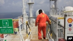 A Shell employee is seen aboard an oil vessel off the coast of Nigeria.