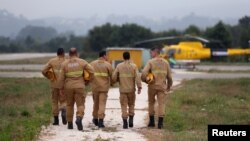 Members of an elite team of firefighters arrive for a training session at their base near Pombal, Portugal, July 13, 2018.