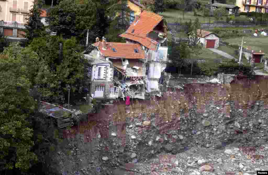 An aerial view shows damaged houses in Saint-Martin-Vesubie, southern France, as clean-up operations continue after storm Alex hit the Alpes-Maritimes department, bringing record rainfall and causing heavy flooding that swept away roads and damaged homes.