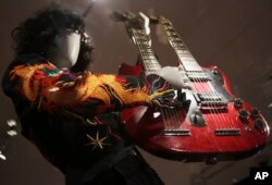 A double-neck guitar played by Jimmy Page of Led Zeppelin is displayed at the exhibit "Play It Loud: Instruments of Rock & Roll," at the Metropolitan Museum of Art in New York, April 1, 2019.