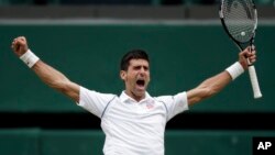 Novak Djokovic of Serbia celebrates winning the men's singles final against Roger Federer of Switzerland at the All England Lawn Tennis Championships in Wimbledon, London, July 12, 2015. 