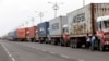 Trucks loaded with containers are lined up outside a terminal at the Jawaharlal Nehru Port Trust in Mumbai, India, June 29, 2017. Operations at a terminal at India's busiest container port have been stalled by the malicious software that suddenly burst across the world’s computer screens Tuesday. 