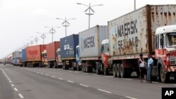 Trucks loaded with containers are lined up outside a terminal at the Jawaharlal Nehru Port Trust in Mumbai, India, June 29, 2017. Operations at a terminal at India's busiest container port have been stalled by the malicious software that suddenly burst across the world’s computer screens Tuesday. 