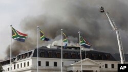 Smoke rises from the Parliament in Cape Town, South Africa, Jan 3, 2022, after the fire re-ignited late afternoon.