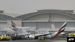 A picture shows a Boing 777 of the UAE airliner Emirates after it caught fire following a crash-landing at Dubai airport on August 3, 2016. 