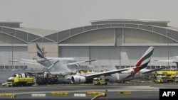 A picture shows a Boing 777 of the UAE airliner Emirates after it caught fire following a crash-landing at Dubai airport on August 3, 2016. 
