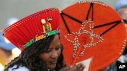 A supporter of the ruling African National Congress party checks her accreditation for the inauguration in Pretoria, South Africa, May 24, 2014.