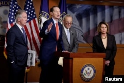 FILE - FILE - Rep. Richard Neal (D-MA), Senator Ron Wyden (D-OR), Senate Minority Leader Chuck Schumer (D-NY) and House Minority Leader Nancy Pelosi (D-CA) react to Republican legislation to overhaul the tax code on Capitol Hill in Washington, Nov. 2, 2017.