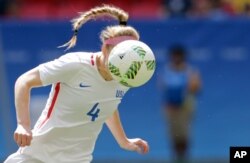 United States' Becky Sauerbrunn hits a header during a loss in the quarterfinals to Sweden at women's Olympic tournament in Brasilia, Aug. 12, 2016.