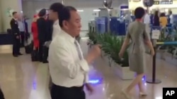 In this image made from video, Kim Yong Chol, in white, a former military intelligence chief who is now Kim Jong Un's top official on inter-Korean relations, walks upon arrival at Beijing airport in Beijing, May 29, 2018. 