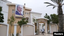 An employee of the Libya Karama Party leaves the party building in Benghazi, Libya, Nov. 9, 2021.