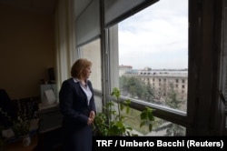 FILE - Ecaterina Berejan, the secretary of Moldova’s national anti-trafficking committee, stands in her office in Chisinau, Moldova, April 5, 2018.