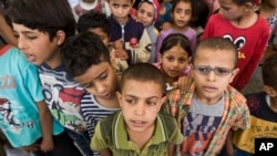 FILE - Displaced boys who fled their home after a Saudi-led airstrike destroyed their houses, live in a school in Sanaa, Yemen.