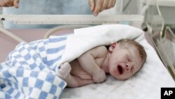 An infant boy cries shortly after being born.