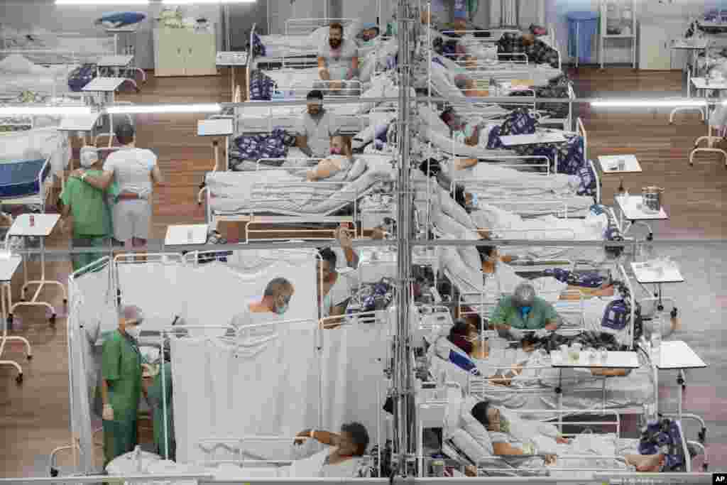 COVID-19 patients lie on beds at a field hospital built inside a sports coliseum in Santo Andre, on the outskirts of Sao Paulo, Brazil.