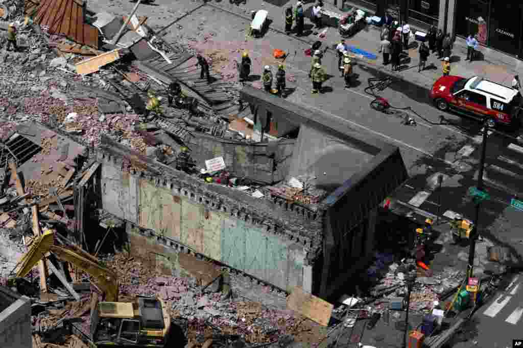 Rescue personnel search the scene of a building collapse in Philadelphia, Pennsylvania, June 5, 2013.