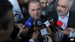 Iranian scientist Mojtaba Atarodi (C), who was in U.S. custody since late 2011, speaks to journalists, upon his arrival at the Imam Khomeini airport outside Tehran, April 27, 2013.