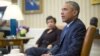 Attorney General Loretta Lynch listens as President Barack Obama speaks in the Oval Office of the White House in Washington, Jan. 4, 2016, during a meeting with law enforcement officials to discuss executive actions the president can take to curb gun violence.