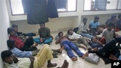 Ethnic Rohingya boat people rest after being rescued at sea, at a port in Aceh Besar, Aceh province, Indonesia, February 16, 2011 (file photo)