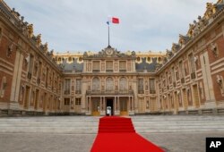 FILE - The red carpet is set up prior to a ceremony at the Palace of Versailles, near Paris, France, May 29, 2017.
