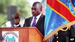 FILE - Incumbent Congo President Joseph Kabila holds the Congolese flag as he takes the oath of office as he is sworn in for another term, in Kinshasa, Democratic Republic of Congo.