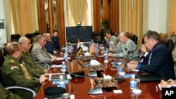 Iraq's Defense Minister Khaled al-Obeidi, third left, meets with U.S. Army General Martin Dempsey, third right, chairman of the Joint Chiefs of Staff, at the defense ministry in Baghdad, Saturday, Nov. 15, 2014. 