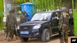 FILE - Members of the Kenya Defense Forces guard the main gate of the Garissa University College compound that was the scene of an attack by al-Shabab gunmen, in Garissa, April 6, 2015.