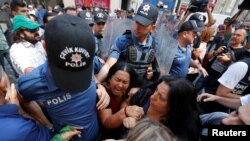FILE - Demonstrators scuffle with the police as they prevent Saturday Mothers' 700th gathering, that meets every week, demanding to know the fate of their missing relatives, claimed to be last seen in the hands of security forces, in central Istanbul, August 25, 2018. 