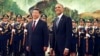 FILE - U.S. President Barack Obama, right, smiles after a group of children waved flags and flowers to cheer him during a welcome ceremony with Chinese President Xi Jinping at the Great Hall of the People in Beijing, China, Nov. 12, 2014.