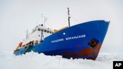 FILE - In this image provided by Australasian Antarctic Expedition/Footloose Fotography the Russian ship MV Akademik Shokalskiy is trapped in thick Antarctic ice 1,500 nautical miles south of Hobart, Australia, Dec. 27, 2013. 
