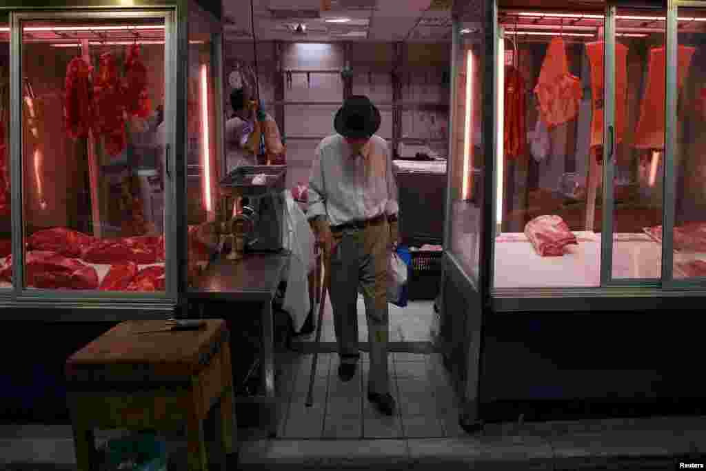 A man exits a butcher shop at the main food market in central Athens, July 20, 2015.