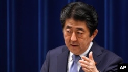 FILE - Japan's Prime Minister Shinzo Abe answers a question from a journalist during a press conference at the prime minister's official residence in Tokyo, July 20, 2018. 