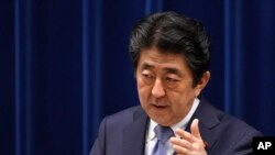 Japan's Prime Minister Shinzo Abe answers a question from a journalist during a press conference at the prime minister's official residence in Tokyo, July 20, 2018. 