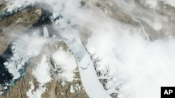 Satellite image provided by NASA shows calving, crescent-shaped crack at center, on the Petermann Glacier in northwestern Greenland. An iceberg twice the size of Manhattan tore off one of Greenland's largest glaciers, July 19, 2012