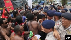 Aktivis Papua berhadapan dengan polisi saat hendak melakukan pawai menandai peringatan 53 tahun berdirinya Organisasi Papua Merdeka (OPM) di Jakarta, 1 Desember 2014 (Foto: dok).