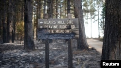 Papan penunjuk papan di White Meadows, sebelah timur laut California, terlihat hangus terbakar (20/9).