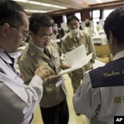 Teams of government and nuclear specialists at the emergency rescue headquarters analyze data from the leaked radiation from the Fukushima nuclear facilitiesin Fukushima, Japan, March 19, 2011