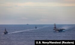 Japan Maritime Self-Defense Force training vessels JS Kashima and JS Shimayuki conduct a passing exercise (PASSEX) with the Nimitz-class nuclear-powered aircraft carrier USS Ronald Reagan in the South China Sea, July 7, 2020.