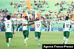 Nigeria's forward Samuel Chukwueze (C) celebrates with teammates after scoring the opening goal during the Group D Africa Cup of Nations (CAN) 2021 football match between Nigeria and Sudan at Stade Roumde Adjia in Garoua, Jan. 15, 2022.