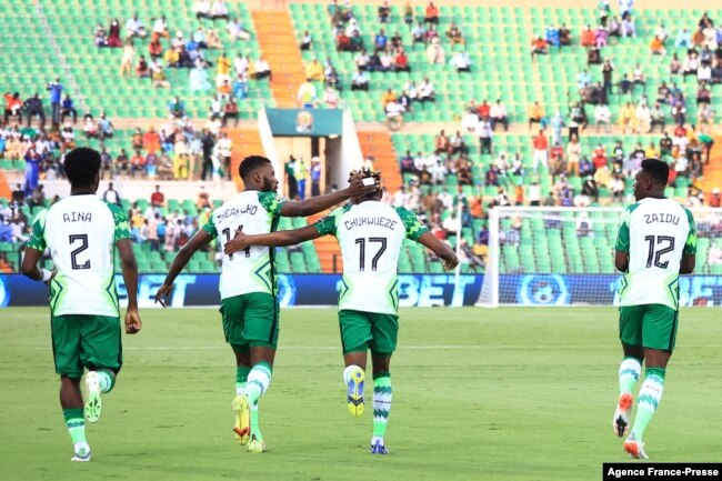 Nigeria's forward Samuel Chukwueze (C) celebrates with teammates after scoring the opening goal during the Group D Africa Cup of Nations (CAN) 2021 football match between Nigeria and Sudan at Stade Roumde Adjia in Garoua, Jan. 15, 2022.