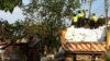 Thai Flood Volunteers Unload Sandbags in Front of Flooded Temple at North Edge of Bangkok