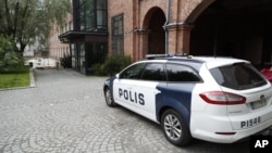 FILE - A police car parks outside Pirkanmaa district court in Tampere, Finland, where five members of Cuba's national volleyball team were convicted Tuesday of aggravated rape. 