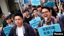 Demonstrators march during a protest to demand authorities scrap a proposed extradition bill with China, in Hong Kong, China, March 31, 2019.