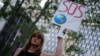 A woman displays a placard during a demonstration in New York on June 1, 2017, to protest U.S. President Donald Trump's decision to pull out of the 195-nation Paris climate accord deal. 