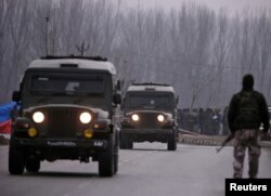 FILE - Indian soldiers stand guard near the site of a Feb. 14 suicide bomb attack in Lethpora in south Kashmir's Pulwama district, Feb. 15, 2019.