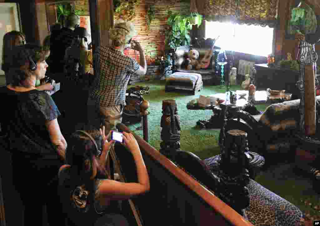 This Aug. 2010 photo shows tourists viewing the Jungle Room at Graceland, Elvis Presley's home in Memphis, Tenn. 
