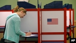 FILE - Kate Irish casts her vote at the Durham County Library North Regional in Durham, N.C., May 8, 2018.